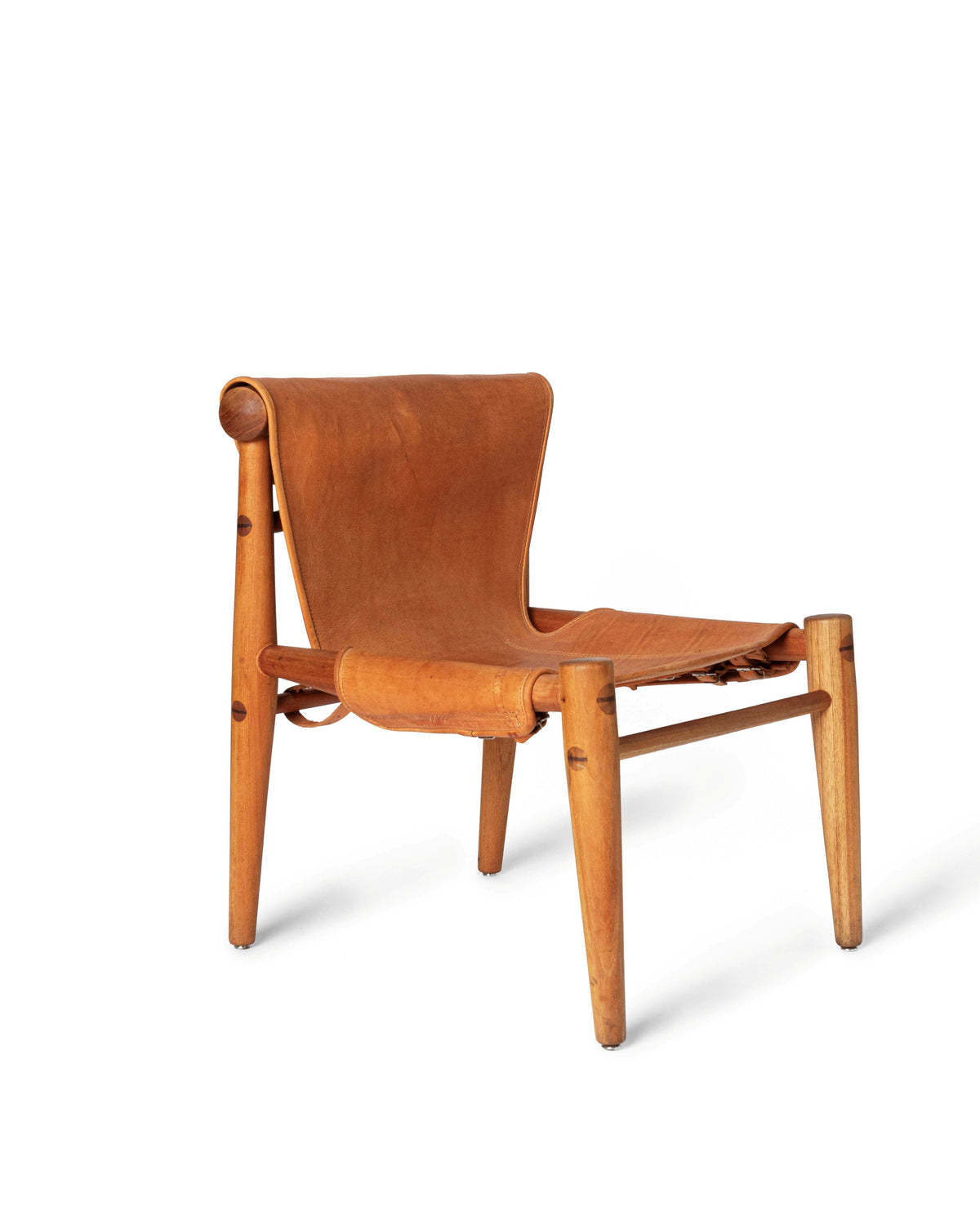 A mid-century modern wooden armchair with a curved backrest and seat, upholstered in warm tan leather, shown on a plain white background.