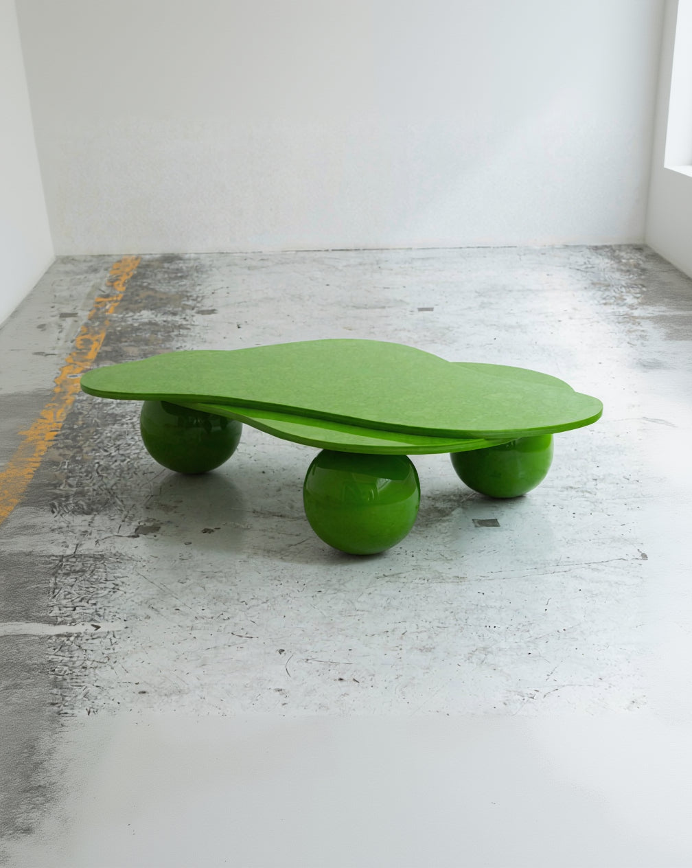 Green balance board on a concrete floor with a white wall background