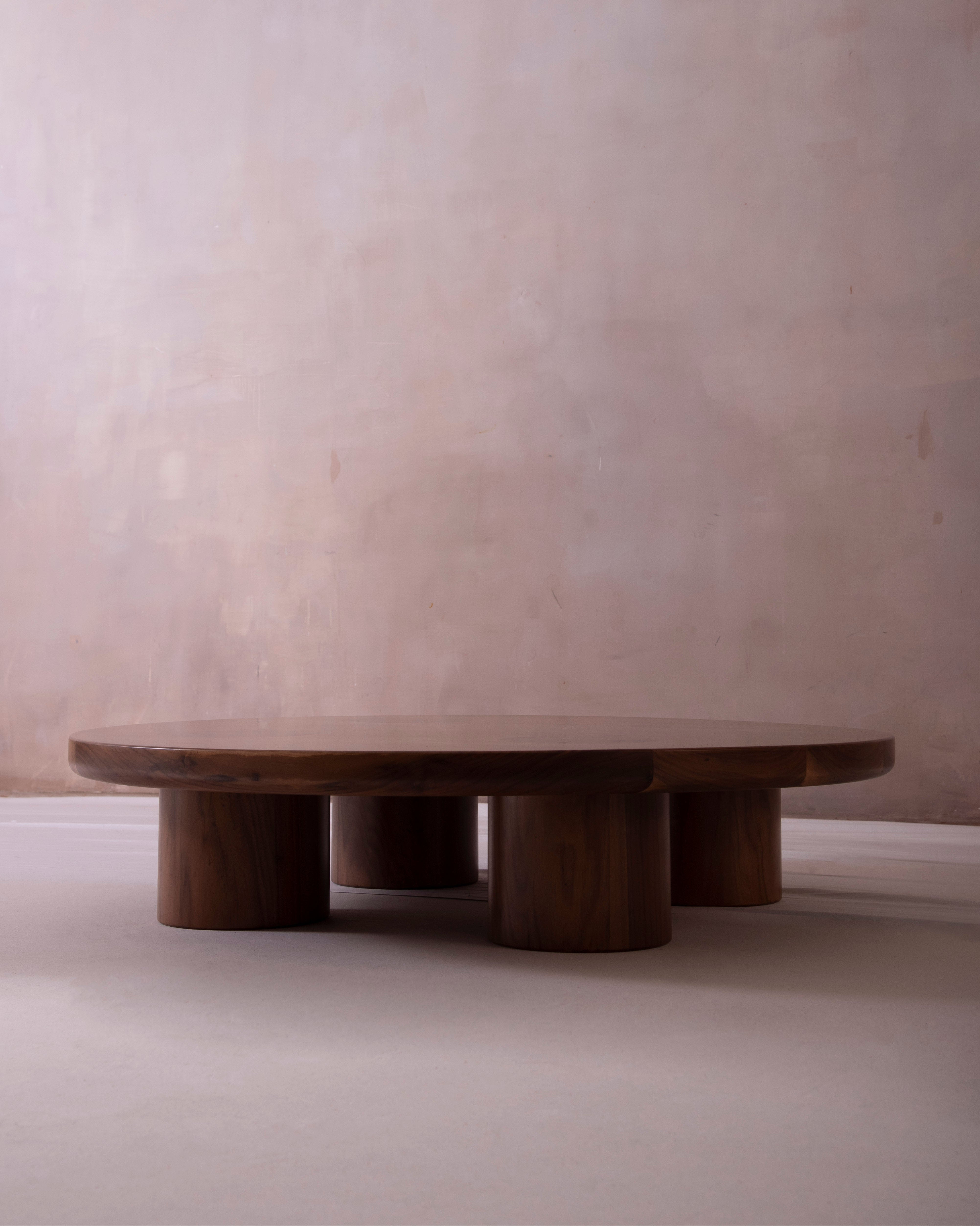 Wooden round table with four cylindrical legs 