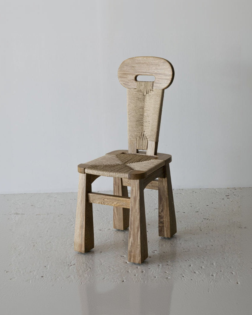 Wooden chair with a unique design on a plain background